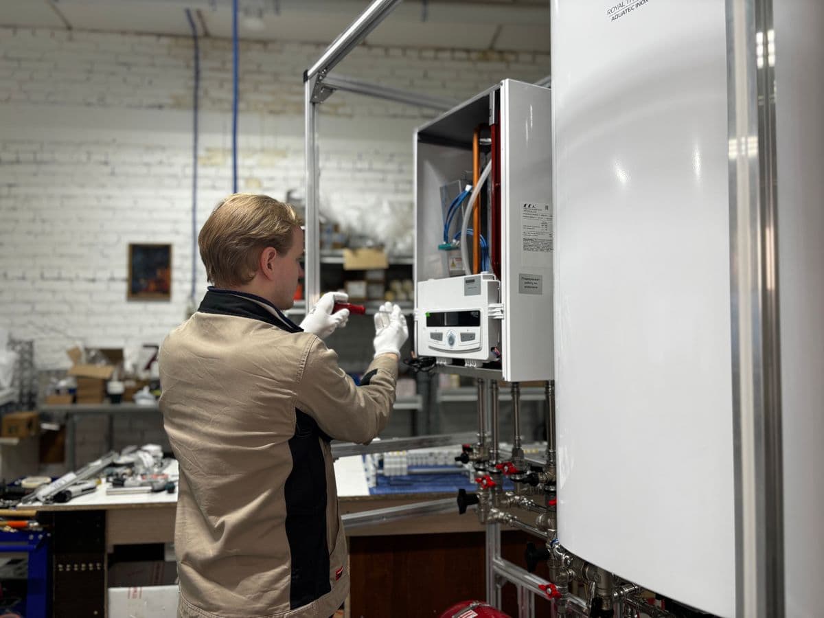 A gas engineer checking a boiler flue during a domestic gas safety inspection