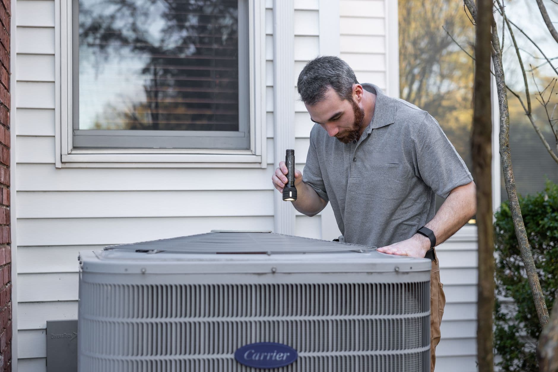 An HVAC engineer working on rooftop plant equipment