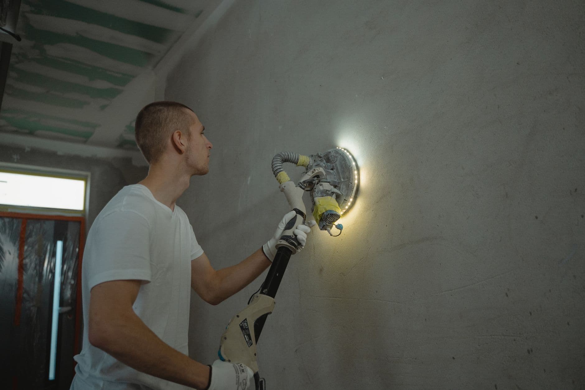 Lone tradesperson working in a residential bathroom with tools laid out