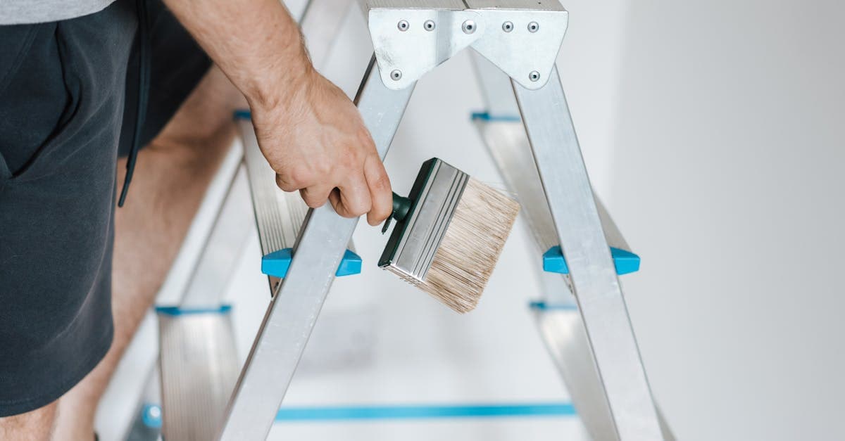 A painter on a ladder during interior renovation work