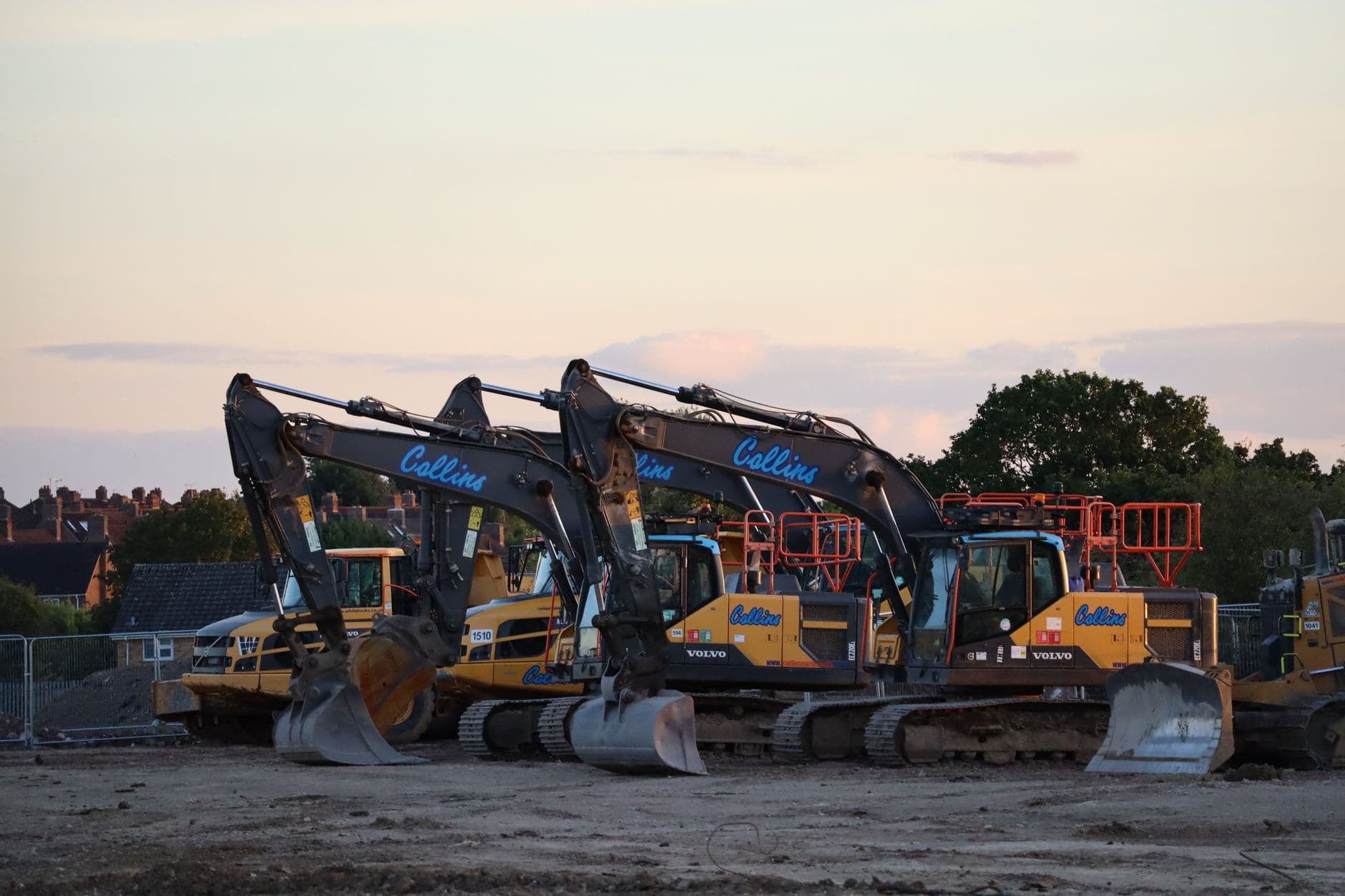 Three excavators working on land excavation at a UK construction site