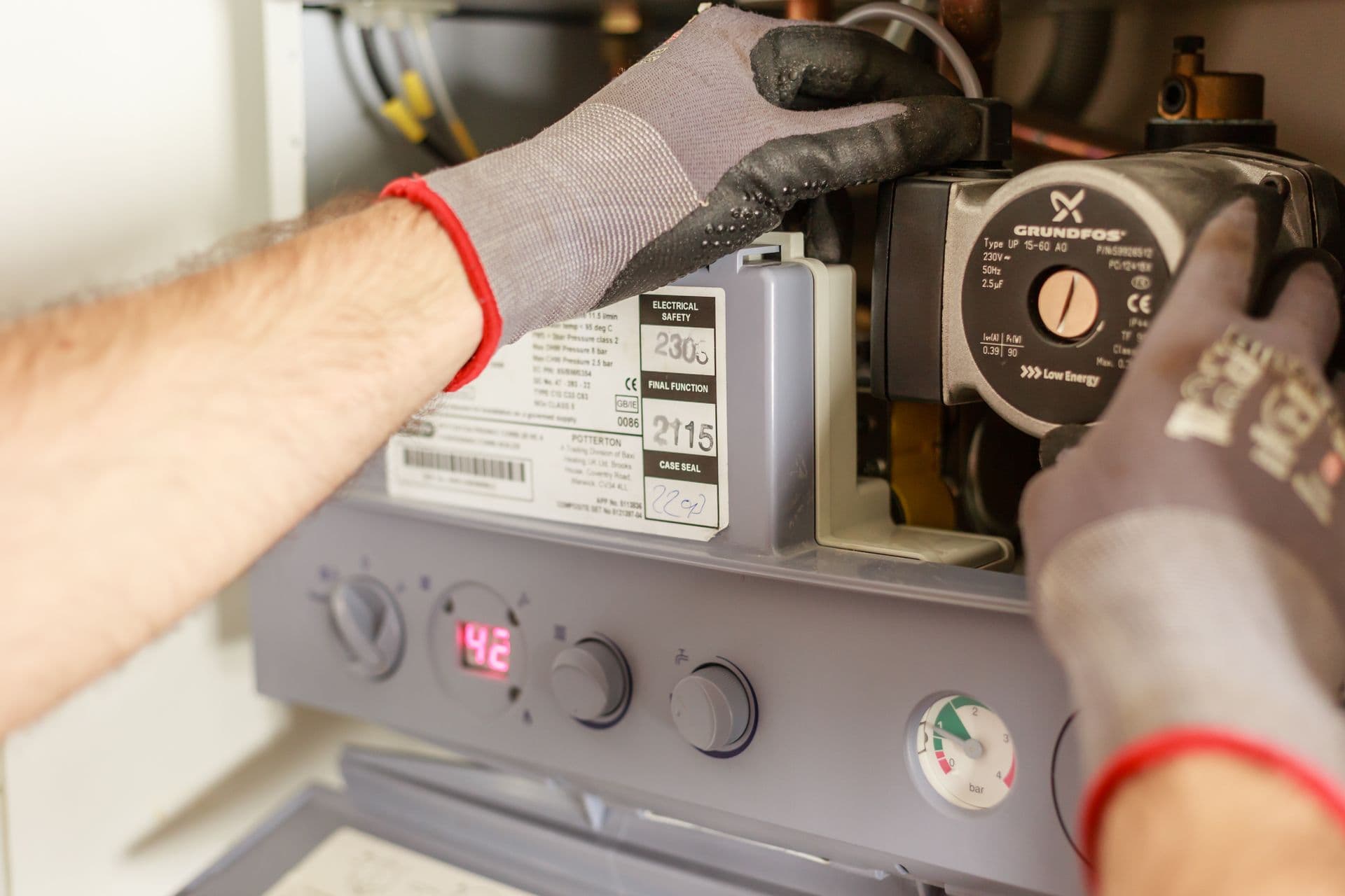 Heating engineer adjusting a boiler system during maintenance